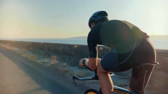 Cyclist On Triathlon Bicycle Sport Recreation. Triathlete Training On Bike.Cycling Exercise On Bike. alt