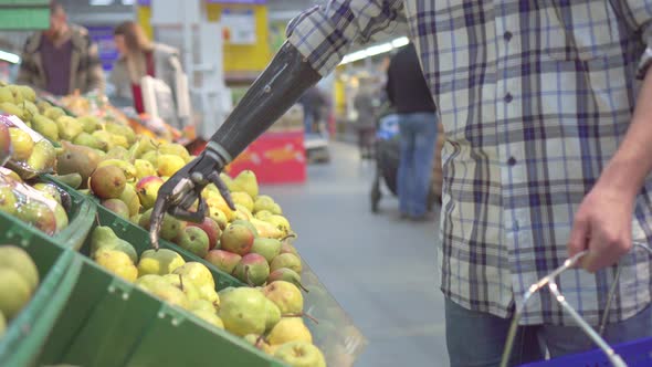 Young Man with a Bionic Prosthetic Arm in a Supermarket Shopping alt
