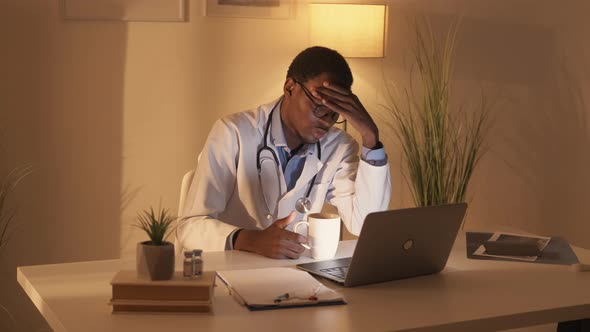 Overworked Doctor Tired Physician Watching Webinar alt
