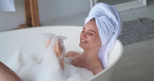 Beautiful Serene Delighted Contented Attractive Woman with White Terry Towel on Her Head Enjoying alt