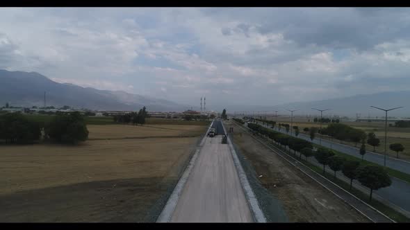 Road Rollers Building the New Asphalt Road. Traffic Motion Aerial View