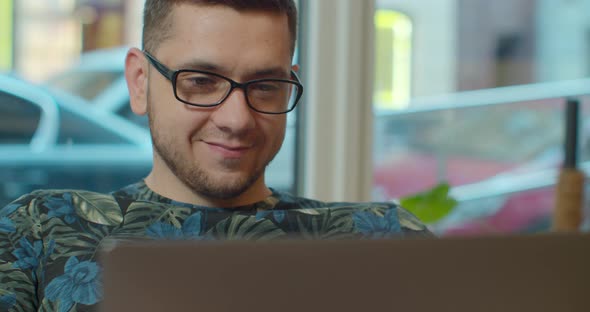 Man Freelancer Using Laptop Online Working in Internet, Guy Typing on Computer Surfing Web Looking alt