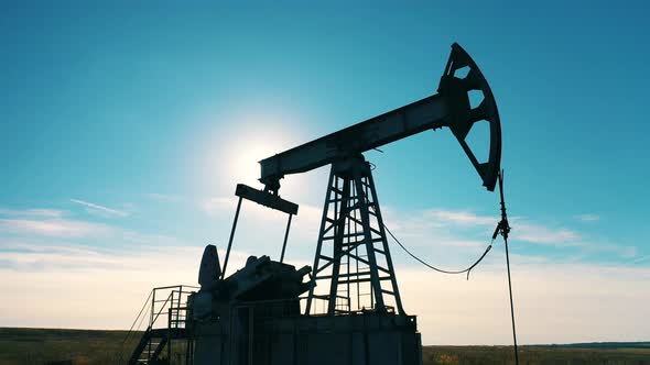 Pumping Unit Working at the Extraction Site in Sunlight alt