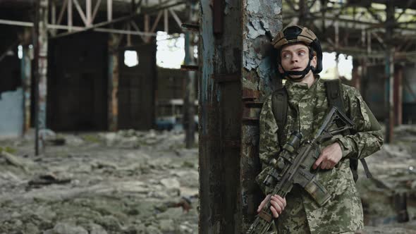 Military Woman in Uniform with Weapon on Old Plant alt