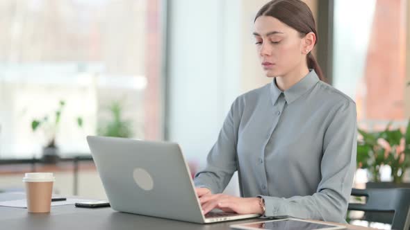 Young Latin Woman Working on Laptop in Office alt