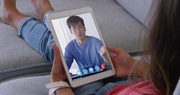 Woman talking on video meeting on her digital tablet alt