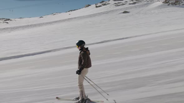 Young Woman Skiing Quickly Down Hill alt