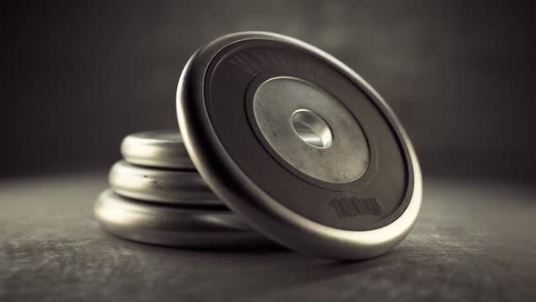 Cast iron black barbell plates isolated on gym floor. Health, fitness, strength alt