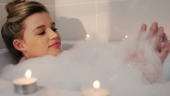 Woman Taking Bath in Bathtub alt