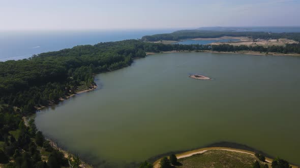 High pan at 300ft over Dune Harbor Lake near Lake Michigan's Coast. alt