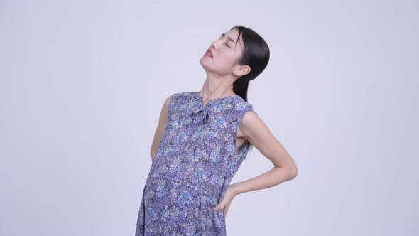 Stressed Pregnant Asian Woman Having Back Pain alt