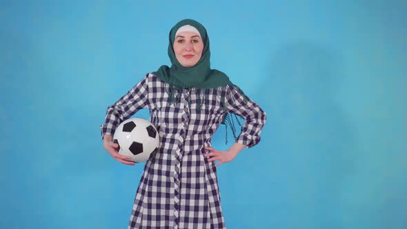 Young Muslim Woman in Hijab with Soccer Ball alt