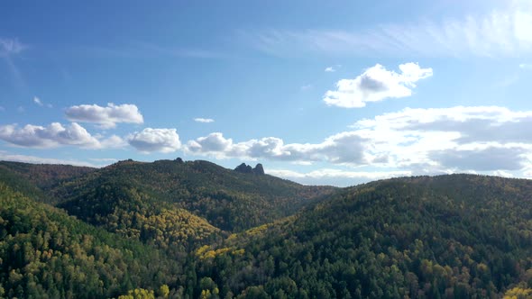 Aerial Hyperlapse of Autumn Forest on a Mountain Range.