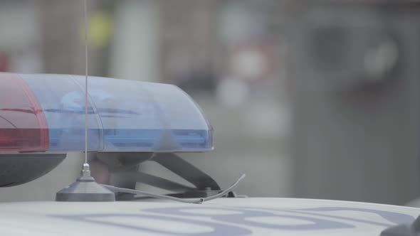 Flashing Flasher on the Roof of a Police Car. Blinker. Close-up. alt