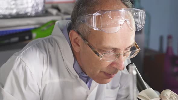 Senior Male Scientist Is Finding Treatment or Vaccine for Coronavirus Infection alt