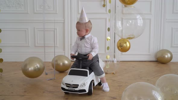 Infant Child Sitting in Electric White Car