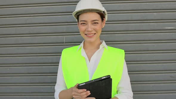 Portrait of factory woman worker smiling to camera