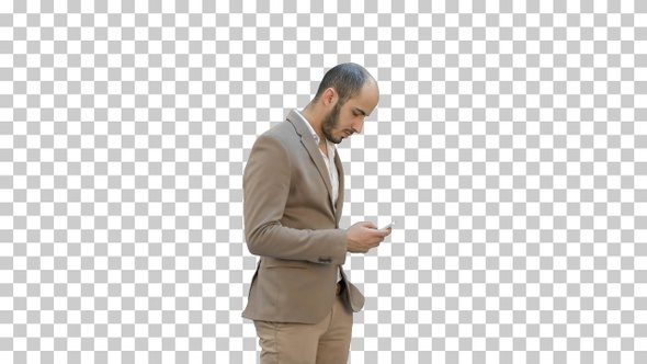 Business man walks in texting on the phone, Alpha Channel