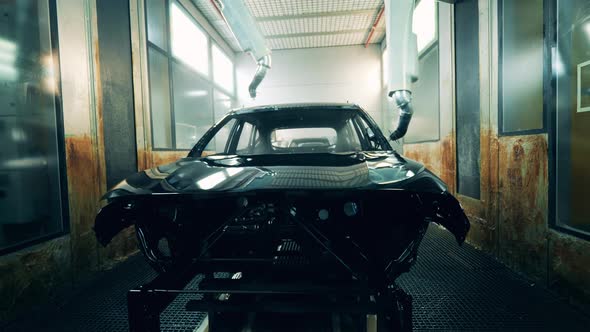 Robotic Machines Are Spraying Zinc Over an Unfinished Car alt