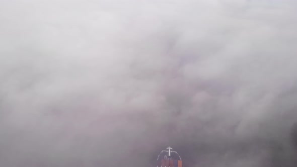 Cargo Ship Travelling By The River Through Fog At Zwijndrecht, Netherlands. - Aerial Shot alt