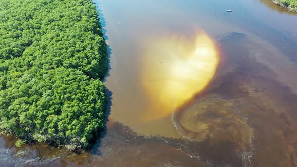 Peaceful dark river scene at coastal city of Itanhaem Sao Paulo Brazil. alt