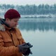 Portrait Man Photographer Takes Pictures of a Lake in the Winter Forest - VideoHive Item for Sale