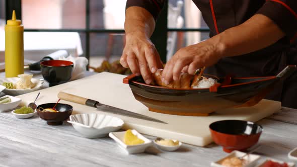 Man's Hands Make Sushi Boat. alt