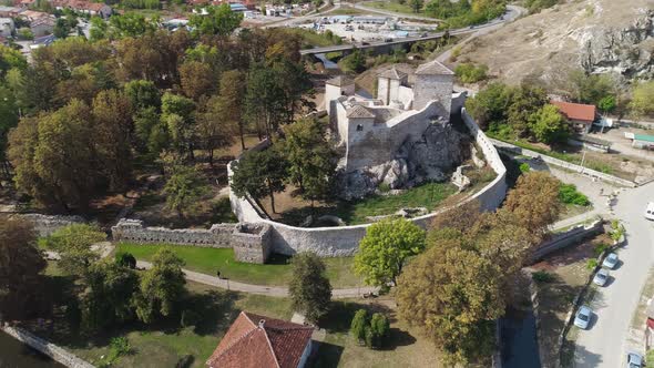 Small medieval fortress in Pirot, Serbia. Town behind drone shot 3