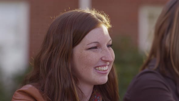 Closeup of college student on campus talking to classmates