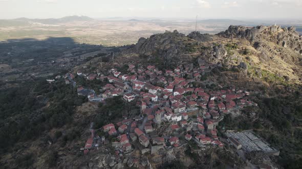 Wide aerial shot of Monsanto historical village in the top of rocky boulder hill