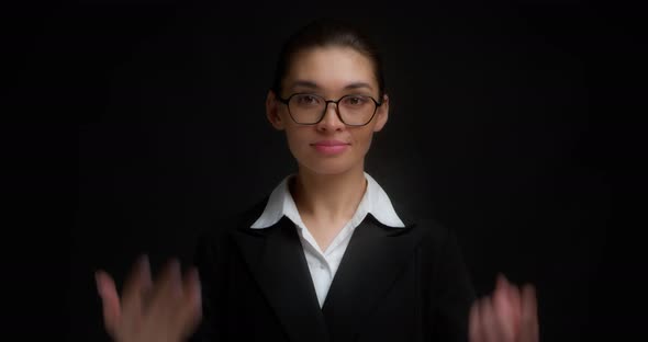 Business Woman with Glasses with a Serious Face Shows Six Finger