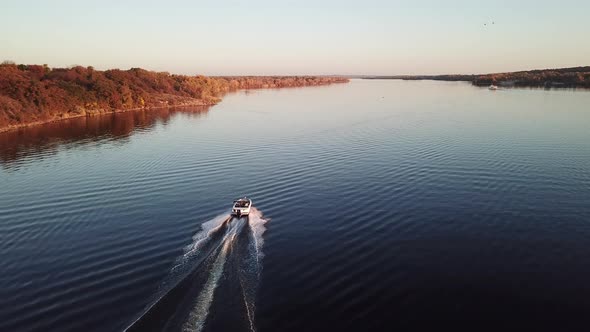  Motor Boat Floating on the River at Sunset