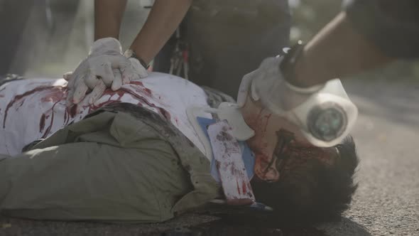 Paramedics Doing Heart Massage for Injured Patient alt