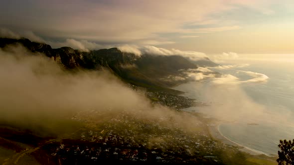 Strange low cloud formations over mountains, Camps Bay in view, Cape Town South Africa alt