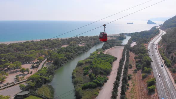 Close-up Flight Next To the Uphill Funicular with the Coast in the Background  alt