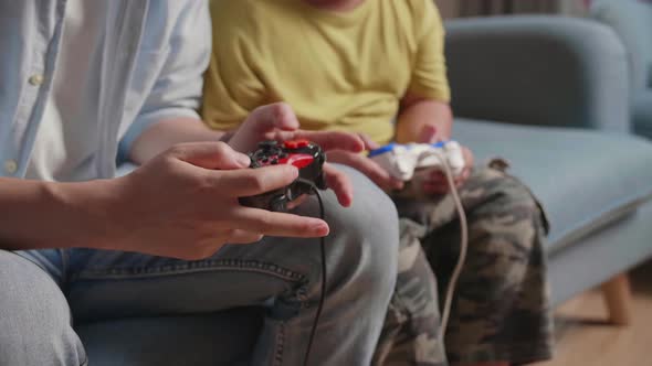 Close Up Of Hand's Father And Son Using Joystick Play Game alt
