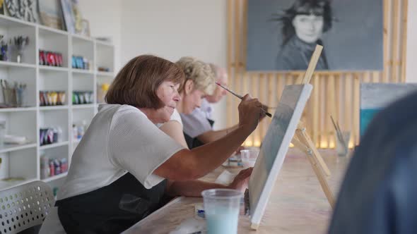 Side View of a Happy Senior People Smiling While Drawing As a Recreational Activity or Therapy in alt