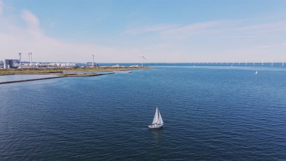 Aerial View of an Industrial Portal with a Yacht Sailing on Water