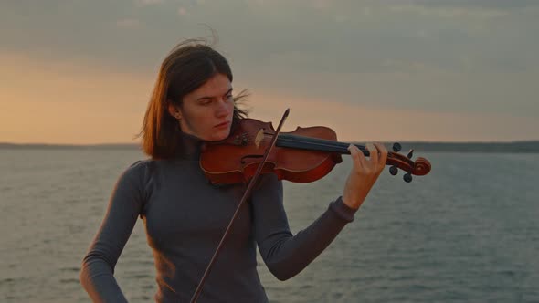 Woman Soloist Is Playing Violin alt