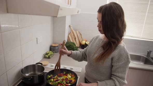 Woman cooking vegetables on the stove for dinner. Health and organic food. Weightloss