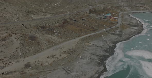 High aerial view of frozen Lake and the Rocky Mountains. Amazing scenic windy road with mountains an alt