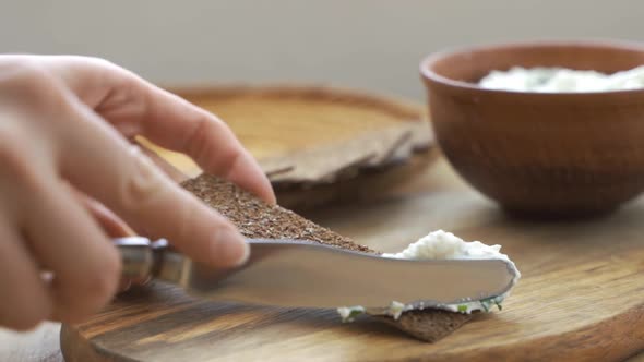 Close Up Shot the Cook Spreads Butter By Knife on Crispy Roasted Toast Bread Making the Sandwich alt