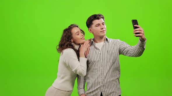 A Man and a Woman are Standing and Smiling alt