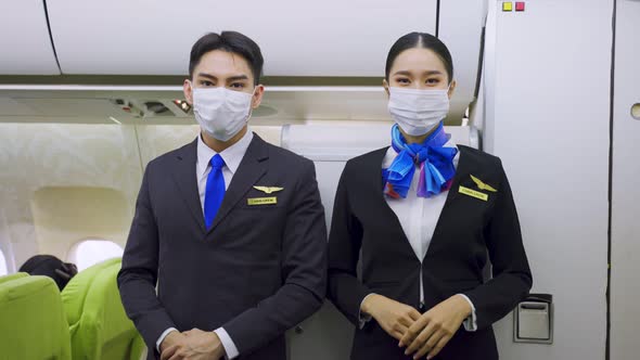 Asian female flight attendant and all passengers wearing face mask to prevent COVID infection. alt