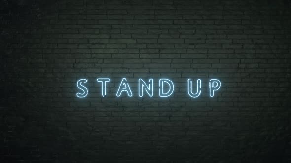 Glowing Stand Up Emblem on Black Brick Wall Background alt