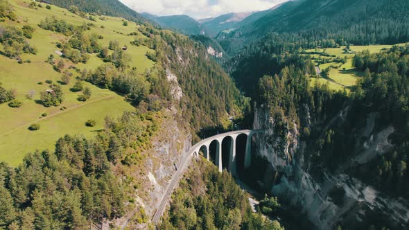 Landwasser Viaduct in Swiss Alps in Summer Aerial View on Green Mountain Valley alt