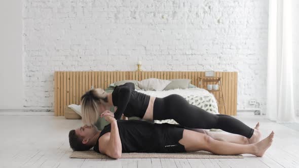 Athletic Sporty Man and Woman Are Doing Push Up Exercises Together at Home