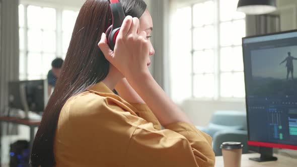 Asian Female Video Editor Start Works With Footage And Sound On Her Personal Computer In Office alt