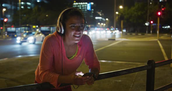 Young woman listening to music before running alt