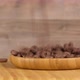 Chocolate rings falling in wooden container.   - VideoHive Item for Sale